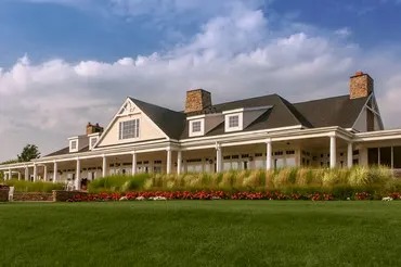 Clubhouse building from the outside with beautiful lawn and shrubbery